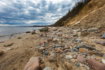 Coast of Baltic sea at the small beach next to high cliffs