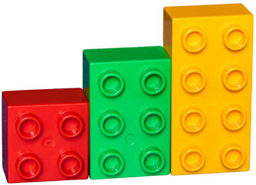 Three plastic building blocks with studs standing next to each other.