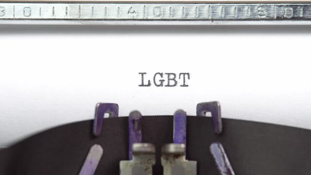 LGBT word closeup being typing and centered on a sheet of paper on old vintage typewriter mechanical