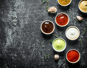 Sauces in bowls with garlic.