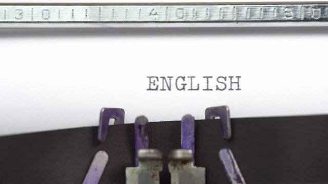 English word closeup being typing and centered on a sheet of paper on old vintage typewriter mechanical