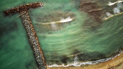 stones and sea of turquoise color. drone shot.