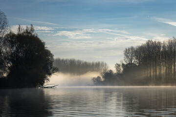 Foggy autumn morning on branches of Danube river in Slovakia.
