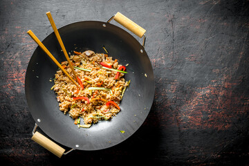 Chinese wok. Rice with vegetables and beef.