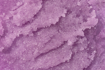 Sugar or salt body scrub texture. Purple indigo scrub - skin care product with fruit extract as cosmetic background with copy space. Macro photo