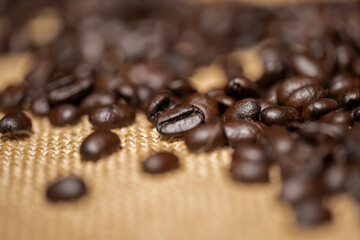 Roasted Coffee Beans on Burlap Sack Background