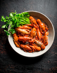 Boiled crayfish in a bowl with parsley.
