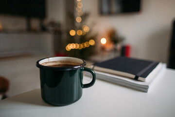 a mug of fragrant coffee on the background of a Christmas tree