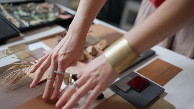 Female architect puts samples on a table in the office