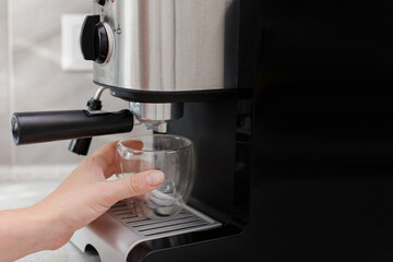 Fototapeta na wymiar prepares coffee in a coffee machine at home. for text