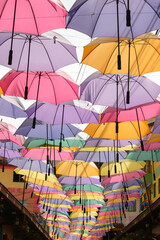 Fototapeta na wymiar Colorful umbrellas on the street. Colorful umbrella screen background. Selective focus.