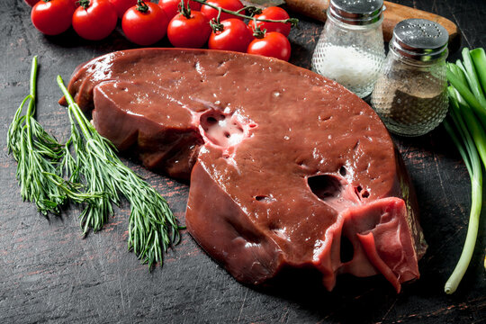 Fresh raw liver with dill, spices and tomatoes.