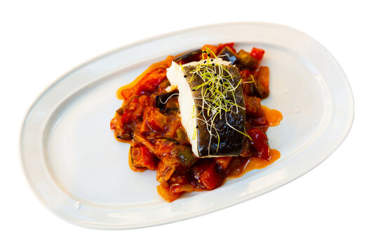 Popular dish of Spanish cuisine is Bacala, made from fish with vegetables. Isolated over white background