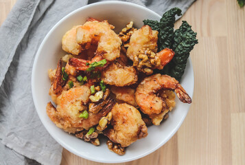 fried shrimp in batter with nuts on a plate close-up, breaded seafood