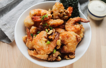fried shrimp in batter with nuts on a plate close-up, breaded seafood