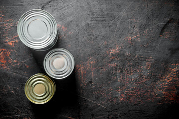 Closed metal cans of canned food.