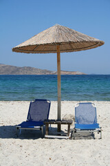 Greece. Kos island. Two chairs and umbrella on the beach