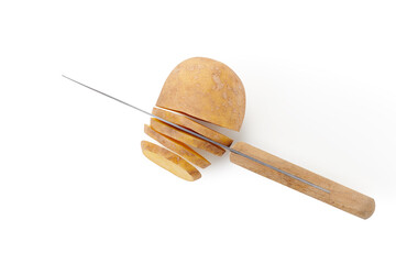 Knife slicing potato on white pastel background