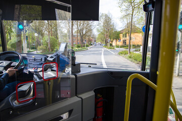 The bus driver's cabin is separated from the bus passengers by a protective barrier