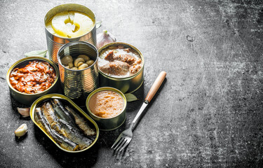 Various open tin cans of canned food.