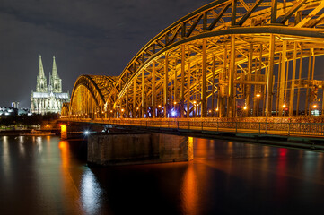 Fototapeta premium Night Cologne Cityscape with Cologne Cathedral and Hohenzollern Bridge. Germany. Long Exposure.