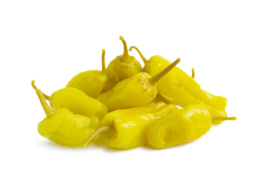 Pile of pickled yellow peppers, pepperoncini or friggitelli isolated on white background. Hot pepper marinated, brined. Traditional Italian and greek cuisine, ingredient for salad, pasta, sauce.