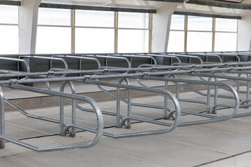 A barn with a corral for cows on the farm. The design of the animal stall.