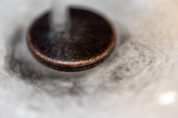 Water falling on an open sink drain. 