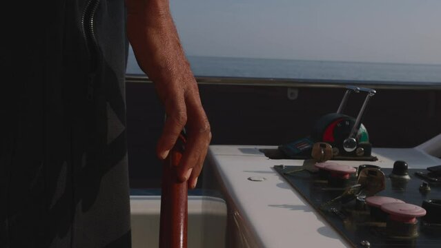 The captain expertly drives the motor yacht, navigating through the water with skill and confidence, as passengers enjoy the view from the deck