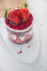 Red cake with strawberries. Strawberry dessert with cream. Sweet strawberry pie isolated on white.