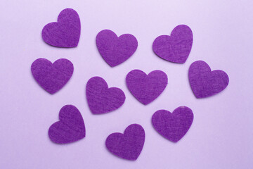 Felt hearts on color background, top view