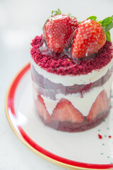 Red cake with strawberries. Strawberry dessert with cream. Sweet strawberry pie isolated on white.
