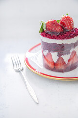 Red cake with strawberries. Strawberry dessert with cream. Sweet strawberry pie isolated on white.