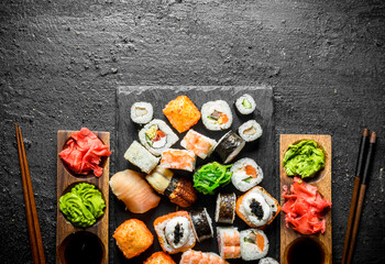 Set of Japanese sushi rolls for two with sauces and chopsticks.