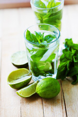 summer coctail background with fresh Mojito over rustic wooden background