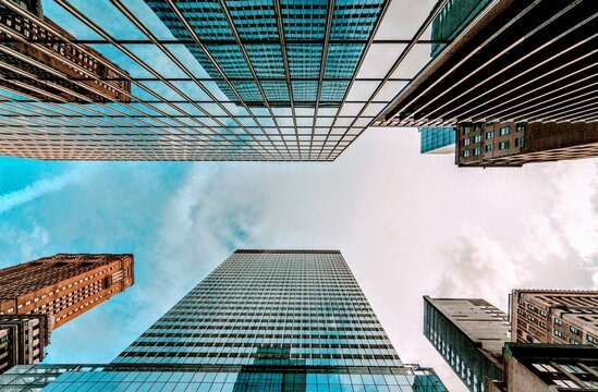 Looking Up Blue Modern Office Building Bottom view of business buildings skyscrapers in New York City Skyline