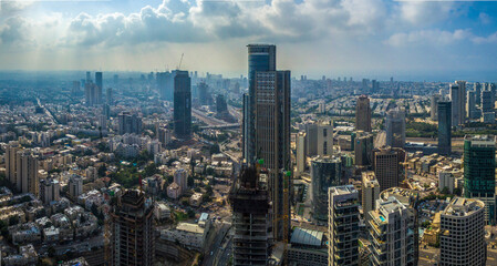 Aerial view of tel aviv and Ramat Gan skyline with urban skyscrapers at sunset, with cloudy sky, Israel