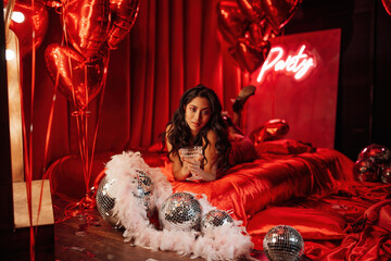 Portrait of smile sexy asian girl glam makeup in red lace lingerie lying on bed at valentines day