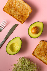Avocado Cut In Half With Toasted Bread And Alfalfa Sprouts