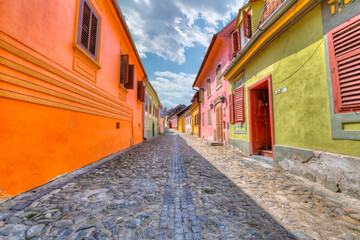 colorful houses exterior with Stone paved old streets in Sighisoara fortress, Transylvania, Romania, Europe