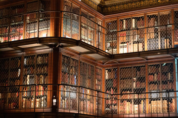 Old books in shelves in the Morgan Library in New York City in the United States