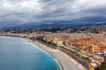 Sandy Beach by Historic City of Nice, France. View from Castle Hill. Cloudy Evening before Sunset.