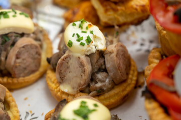 French mini quiche pie with goat cheese and traditional French sausage Andouillette from Troyes in bakery