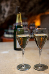 Tasting of rose champagne sparkling wine produced by traditional method in underground caves in Champagne, France