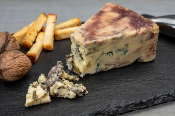Cheese collection, blue stilton English cheese matured in red porto wine served as dessert with bread sticks