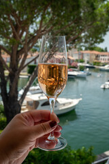 Summer party, drinking of French brut champagne sparkling wine in glasses in yacht harbour of Port Grimaud near Saint-Tropez, French Riviera vacation, France