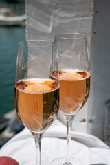 Summer party, drinking of French brut champagne sparkling wine in glasses in yacht harbour of Port Grimaud near Saint-Tropez, French Riviera vacation, France