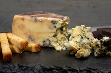 Cheese collection, blue stilton English cheese matured in red porto wine served as dessert with walnuts and chocolate