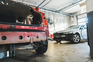 Damaged car with dents and scratches in a car body repair shop ready for repairs. High-quality photo