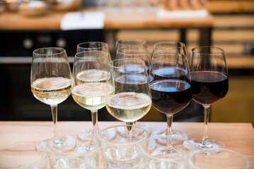 set of glasses with red and white wine on the kitchen table